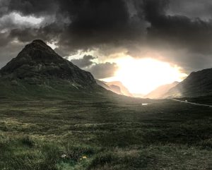 Mountain with sunlight through clouds